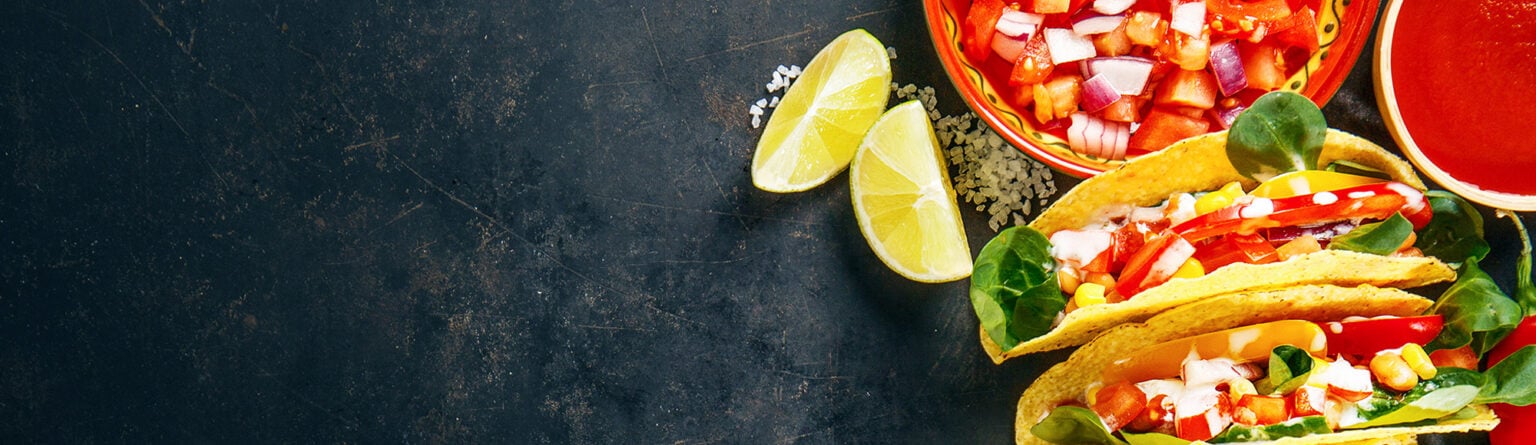 Fresh Mexican tacos with lime and salsa featured on the Las Palapas blog