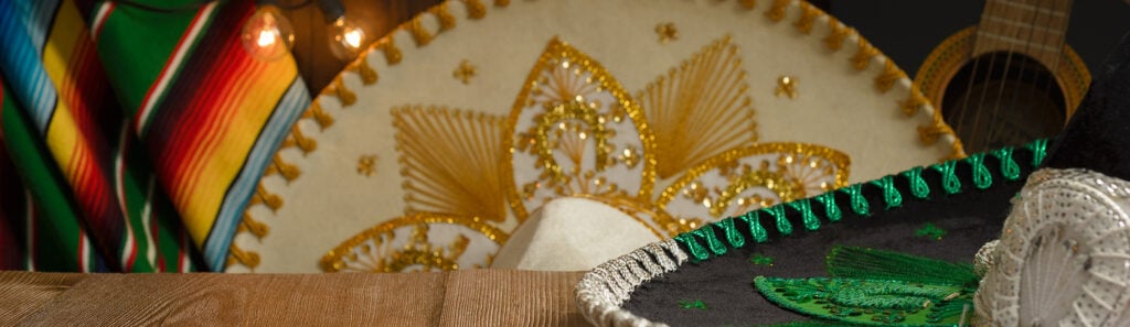 Festive Mexican sombreros, sarape, guitar, and warm string lights for Las Palapas gallery